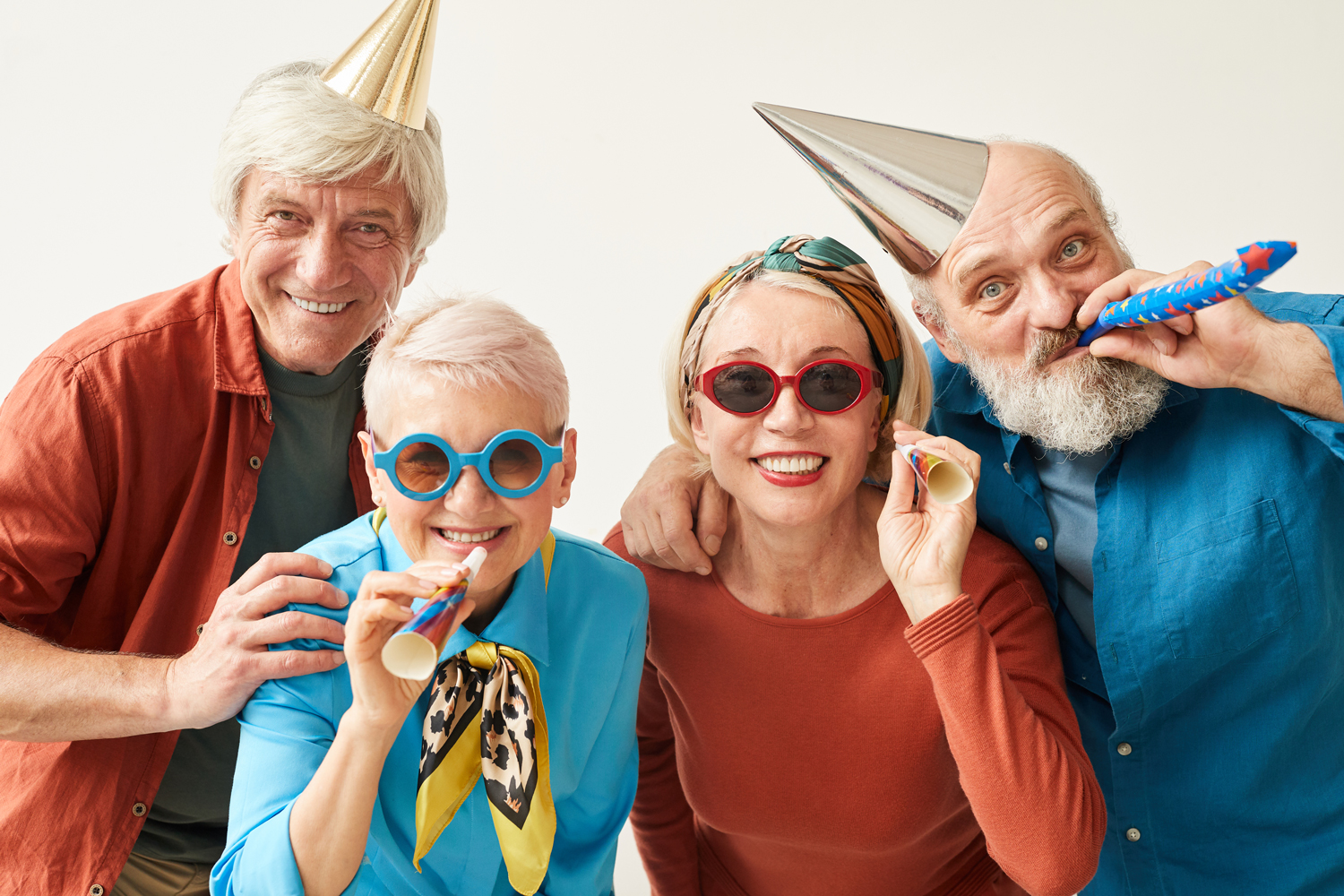 portrait-senior-people-party-hats-sunglasses-smiling-camera-having-fun-against-white-background